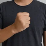 A close-up of an adult hand clenched into a neutral fist.