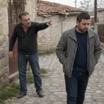 A person angrily making a curse-like gesture while speaking harshly.