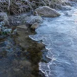 Person visibly freezing in cold weather.