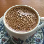 Close-up of Turkish-style coffee with a clear foamy top layer.