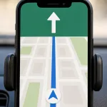 A phone navigation app in a car holder showing a clear go-straight instruction.