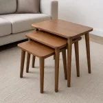 Zigon-style nesting sehpa set with three small tables partially pulled out in a simple living room.